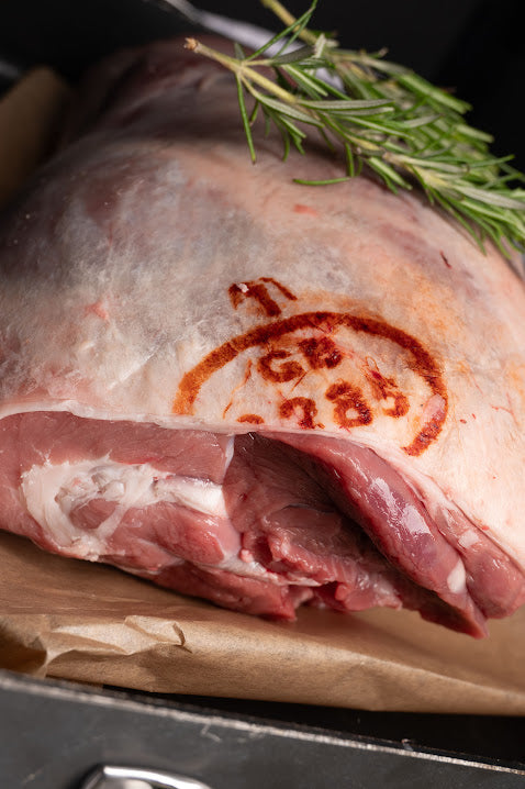 SHOULDER OF LAMB ON BOARD WITH ROSEMARY